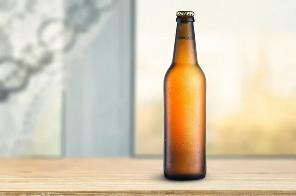 Bottle of beer on table — Stock Photo, Image