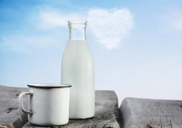 Milk bottle and cup — Stock Photo, Image