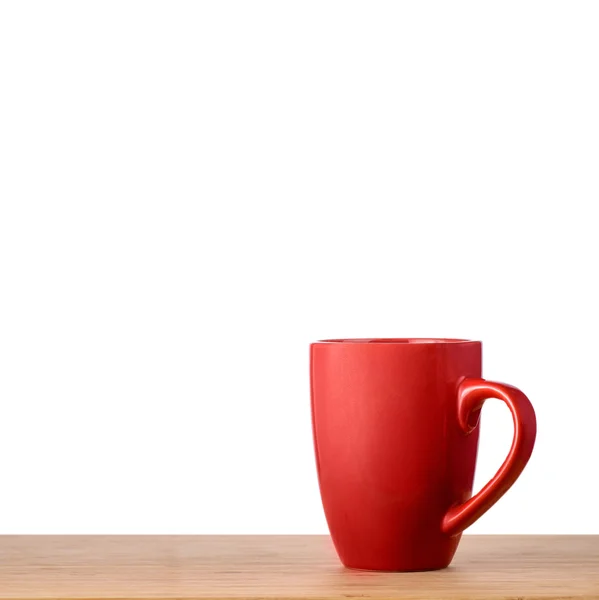 Taza roja en la mesa —  Fotos de Stock