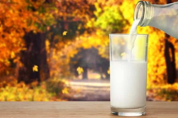 Szklanka mleka na drewnianym stole — Zdjęcie stockowe