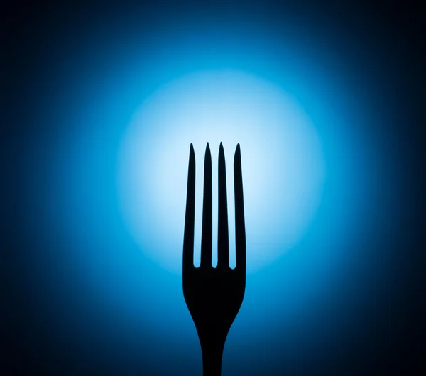 Fork on a blue background — Stock Photo, Image
