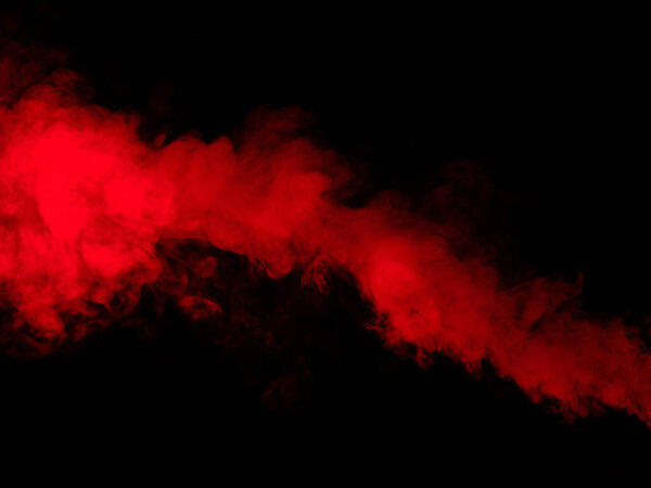 Red smoke isolated on black background