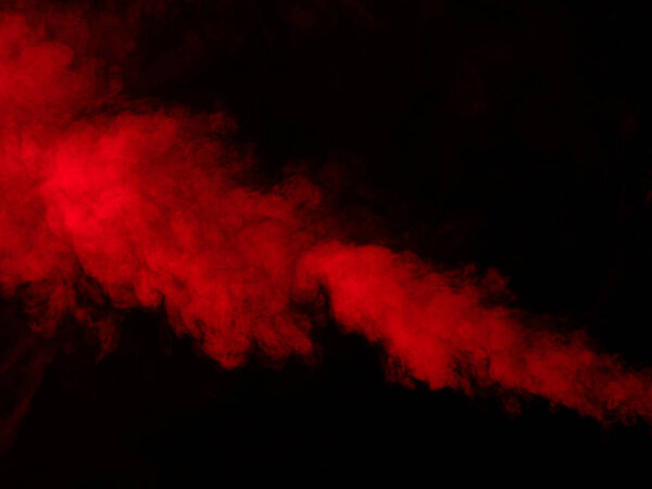 Red smoke isolated on black background