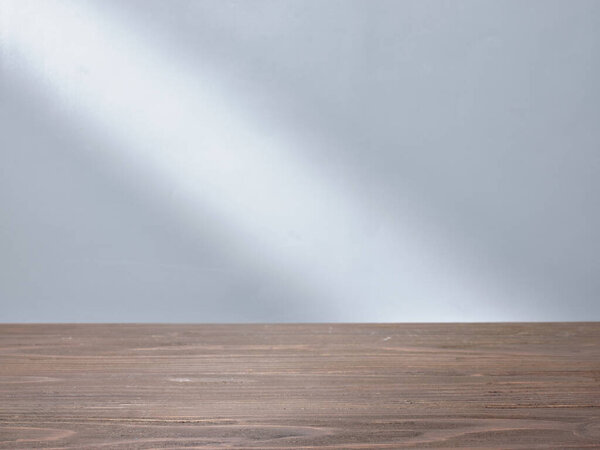 Empty table top with beam of light on background