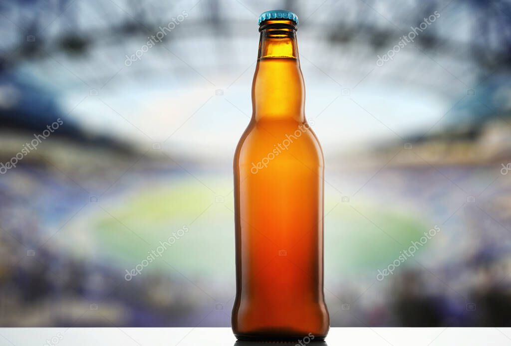 A bottle of beer on the background of a sports stadium