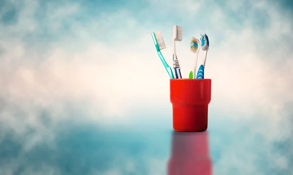 Toothbrushes over abstract background — Stock Photo, Image