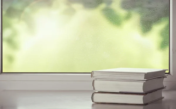 Três livros na janela — Fotografia de Stock