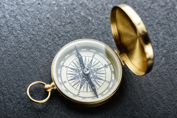 Gold compass on table — Stock Photo, Image