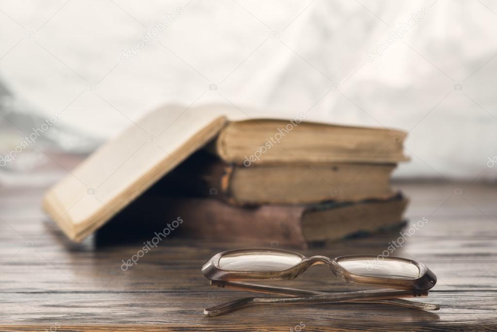 old books and eyeglasses