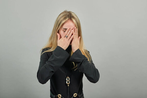 Stressed covered face with hands, crying feels desperate. Fear,shame, violence.