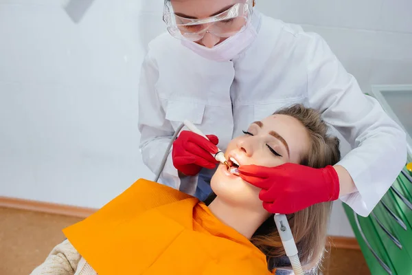 専門の歯科医が患者の口腔の治療と検査をクローズアップで行います — ストック写真