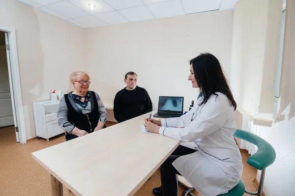 A couple of elderly people at a personal doctor\'s appointment at a medical center. Medicine and healthcare