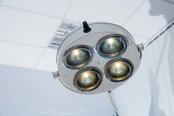 Modern medical lamp close-up in a light operating room. Medicine and surgery