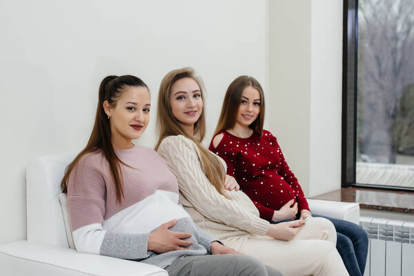 Pregnant girls are waiting for the doctor in the waiting room