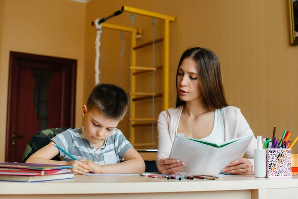 Young Mother Doing Homework Her Son Home Parents Training — Stock Photo, Image