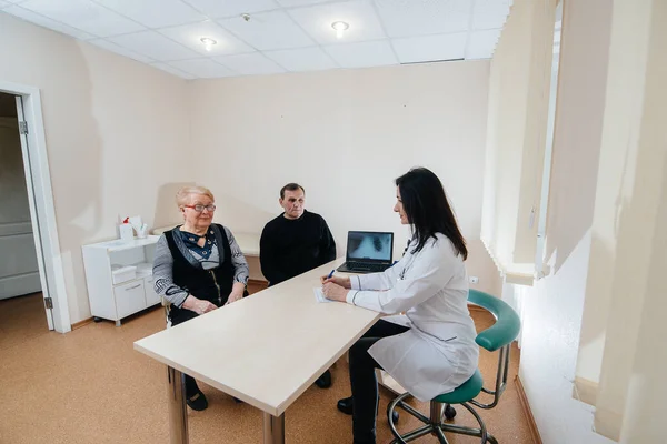 A couple of elderly people at a personal doctor\'s appointment at a medical center. Medicine and healthcare