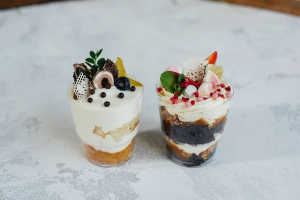 Two beautiful and delicious trifle cakes close-up on a light background. Dessert, healthy food