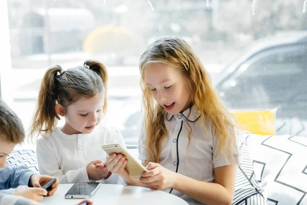 Bambini Siedono Tavolo Caffè Giocano Insieme Telefoni Cellulari Intrattenimento Moderno — Foto Stock