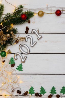 Beyaz Noel arkaplanı şenlikli dekorlar, fenerler, kar taneleri ve Noel ağacı dallarıyla süslenmiş. Noel tebrik kartı. Kış tatili. Mutlu yıllar.