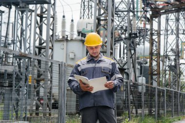 Enerji mühendisi istasyonun ekipmanlarını inceler. Güç mühendisliği. Sanayi
