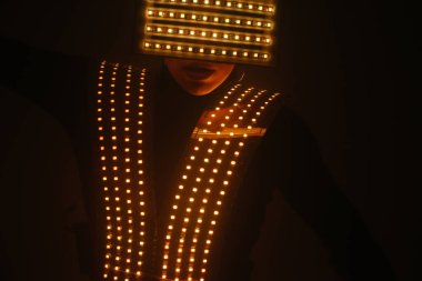 Müzik eşliğinde ultraviyole kıyafetle dans eden seksi disko dansçısı. Partiler ve danslar.