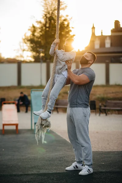 Padre Ayuda Hijo Trepar Una Cuerda Campo Deportes Con Máscaras — Foto de Stock