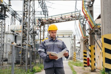 Enerji mühendisi istasyonun ekipmanlarını inceler. Güç mühendisliği. Sanayi