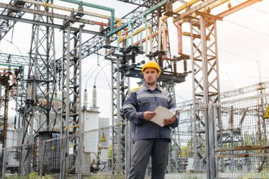 Enerji mühendisi istasyonun ekipmanlarını inceler. Güç mühendisliği. Sanayi
