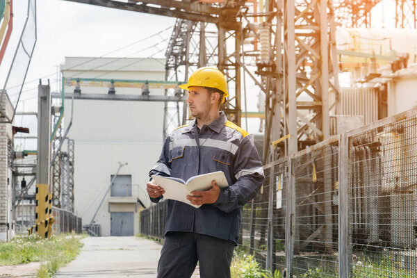 The energy engineer inspects the equipment of the substation. Power engineering. Industry