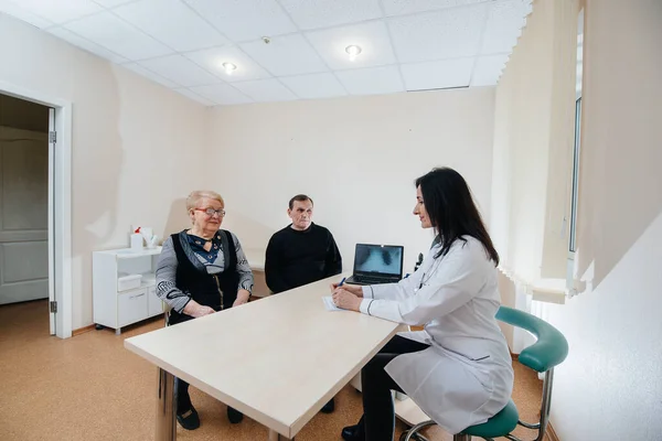 A couple of elderly people at a personal doctor\'s appointment at a medical center. Medicine and healthcare