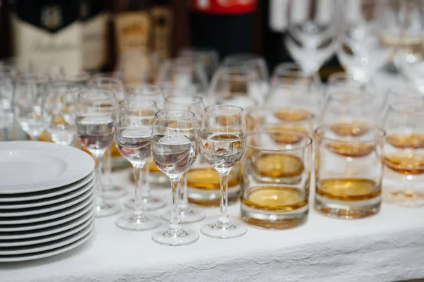 Festive glasses on the festive table during the Banquet. Alcoholic beverage