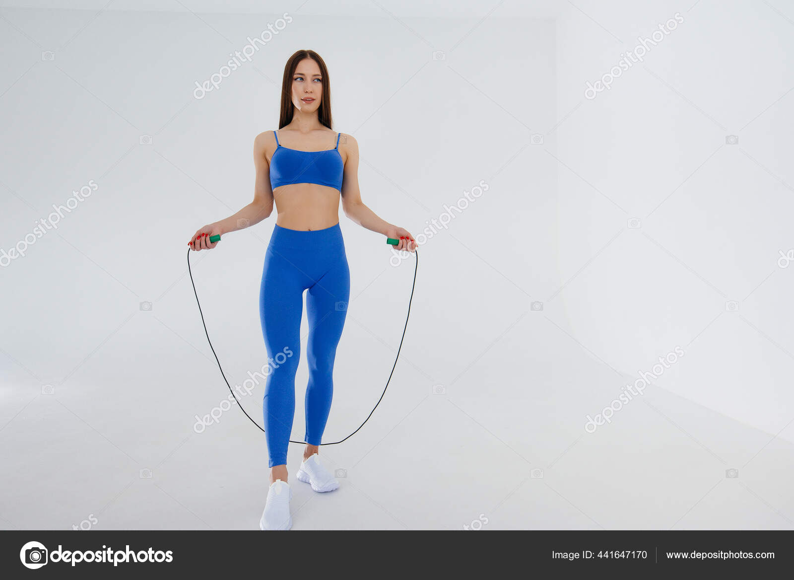 Sexy Junges Mädchen Beim Seilspringen Einem Blauen Trainingsanzug Auf Weißem Stockfotografie