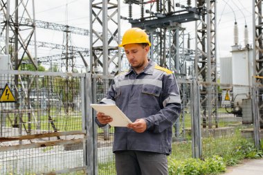Enerji mühendisi istasyonun ekipmanlarını inceler. Güç mühendisliği. Sanayi