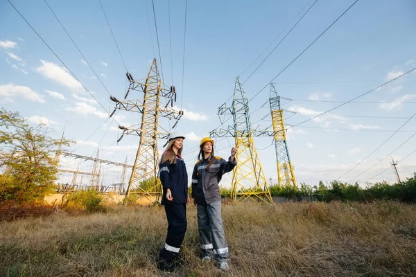 Women\'s collective of energy workers conducts an inspection of equipment and power lines. Energy