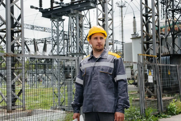 An engineering employee makes a tour and inspection of a modern electrical substation. Energy. Industry
