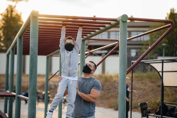 Padre Hijo Practican Deportes Campo Deportes Con Máscaras Durante Atardecer — Foto de Stock