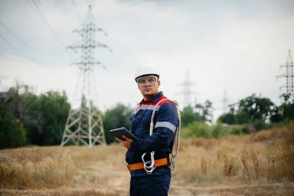An energy worker inspects power lines. Energy