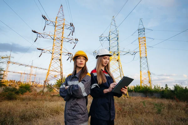 Women\'s collective of energy workers conducts an inspection of equipment and power lines. Energy