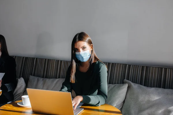 Ein Junges Mädchen Sitzt Mit Maske Einem Café Und Arbeitet — Stockfoto