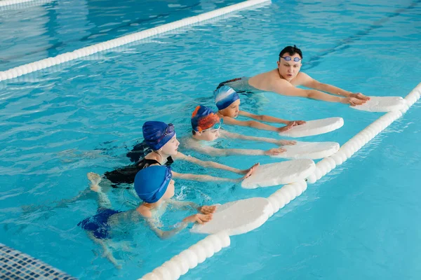 Egy Csapat Fiú Lány Edz Megtanulnak Úszni Medencében Egy Oktatóval — Stock Fotó