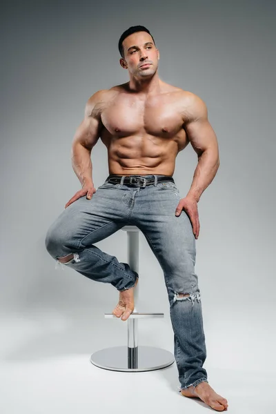 Young Athlete Jeans Poses Sitting Studio Sport — Stock Photo, Image