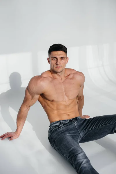 Young Sexy Athlete Perfect Abs Sits Floor Studio Topless Jeans — Stock Photo, Image