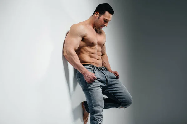 Young Athlete Bodybuilder Poses Studio Topless Jeans Wall Sport — Stock Photo, Image
