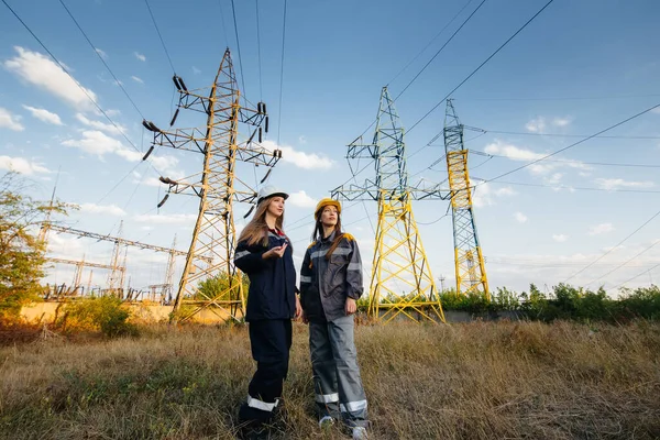 Women\'s collective of energy workers conducts an inspection of equipment and power lines. Energy