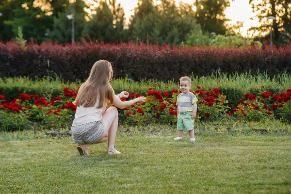 Young Cute Mother Helps Teaches Her Little Son Take His — Stock Photo, Image