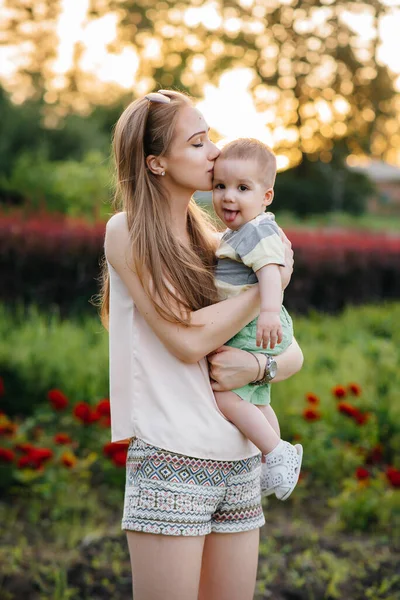 Young Beautiful Mother Kisses Hugs Her Little Son Sunset Park — Stock Photo, Image