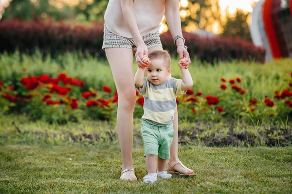 Young Cute Mother Helps Teaches Her Little Son Take His — Stock Photo, Image