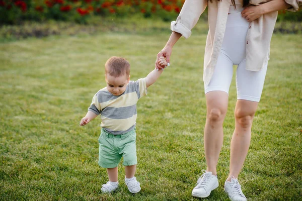 Young Cute Mother Helps Teaches Her Little Son Take His — Stock Photo, Image