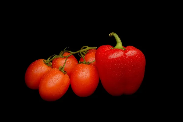 Tomatoes and sweet pepper on black background — Stock Photo, Image