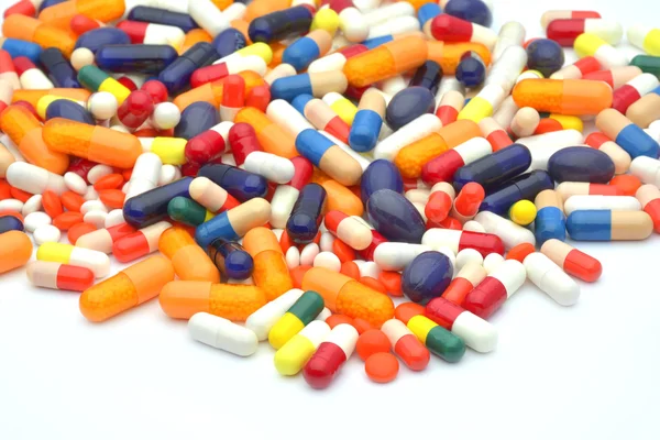 Барвисті таблетки на білому тлі — стокове фото